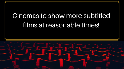 Movie theatre black screen with red chairs in rows facing it. Text on screen says 'cinemas to show more subtitled films at reasonable times'